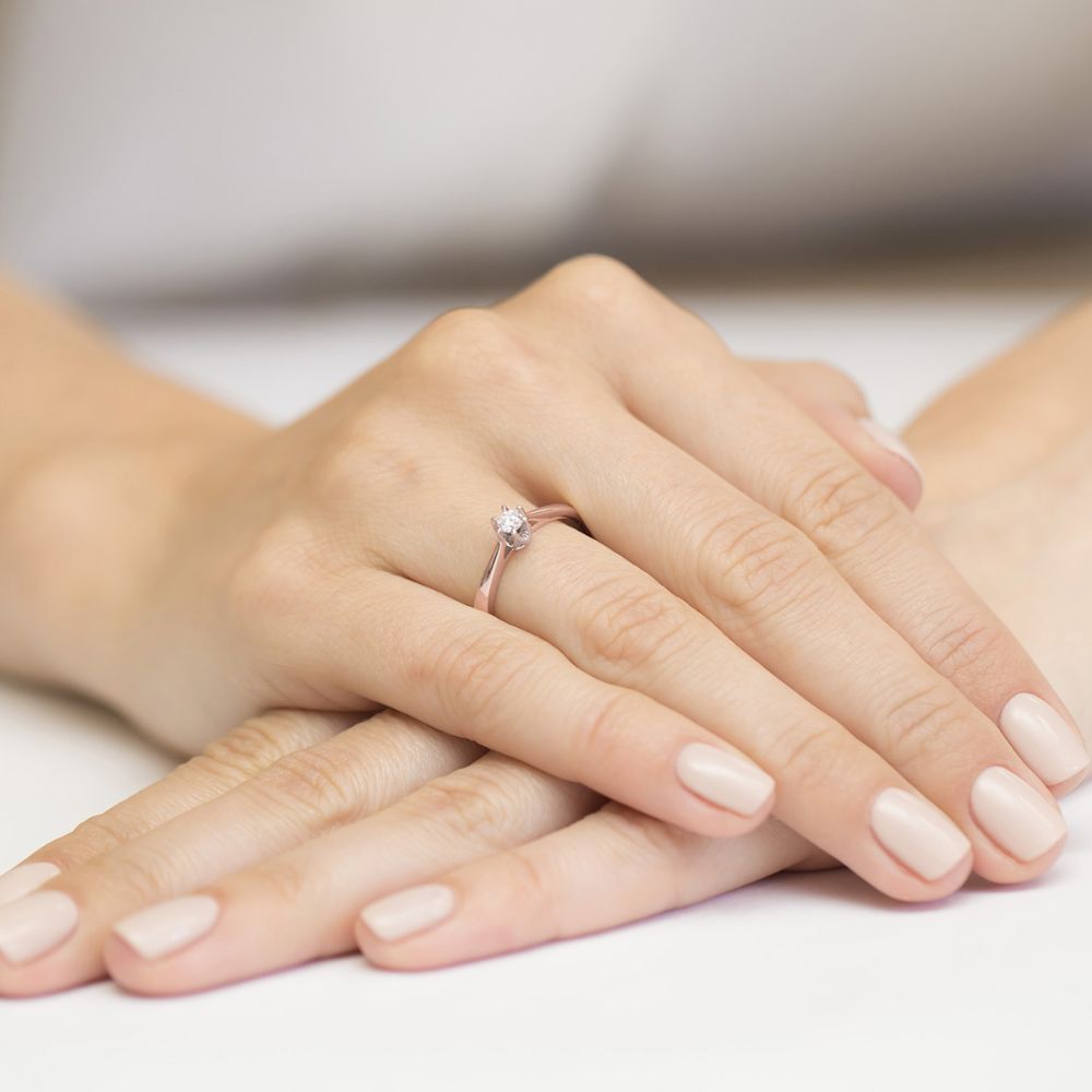 Pierścionek zaręczynowy z brylantem 0,12 ct, różowe złoto 585, zdjęcie na dłoni